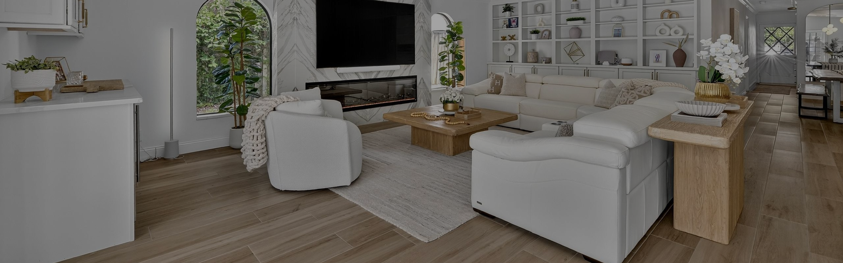 Living room with a custom fireplace and brown couch, beige carpet