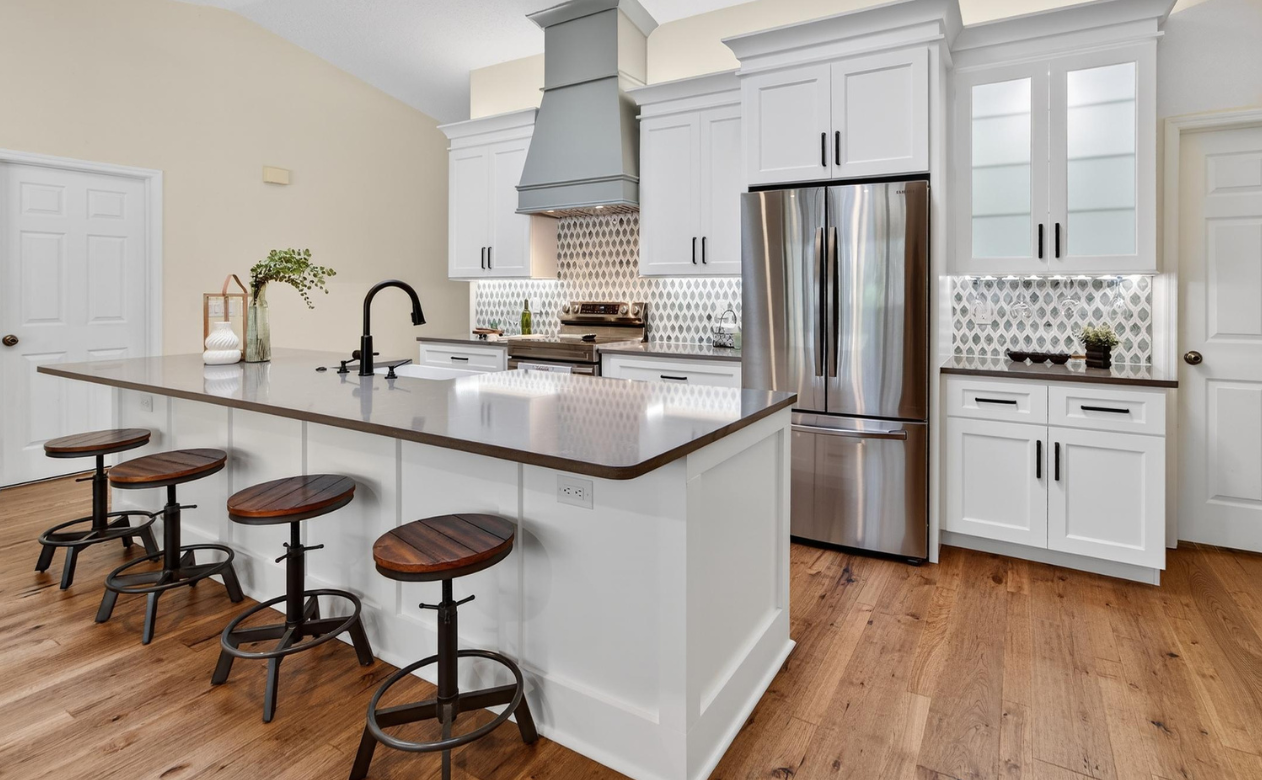 kitchen remodel with white glass-front cabinetry with lighting and custom backsplash