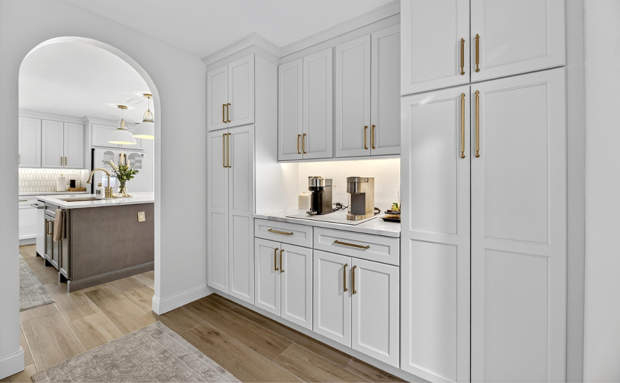 hallway adjacent to a bathroom remodel with coordinated cabinetry for a beverage bar in Tampa, FL