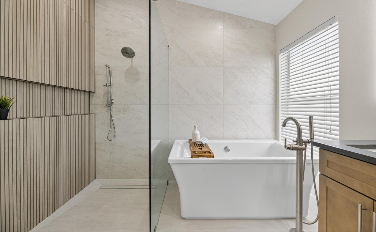 bathroom with soaking tub, barrier free shower and reeded wood accent wall with wall-to-wall niche