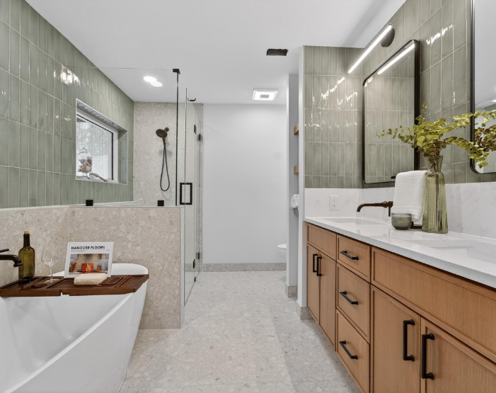 bathroom with green wall tile, custom vanity, soaking tub and custom shower in Lutz, FL