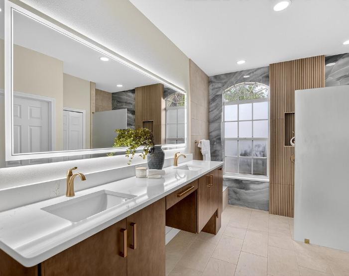 Odessa, FL bathroom renovation with lighted mirrors, walk-in shower, lighted shower niche and custom vanity