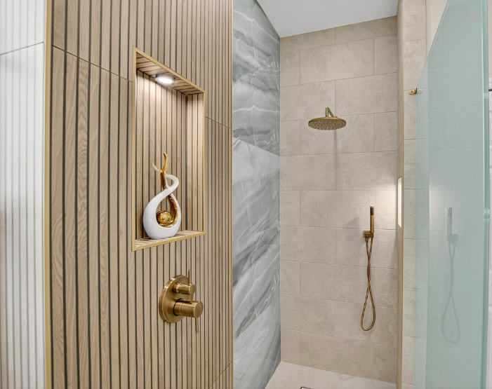 Custom tiled walk-in shower with wood accent and two lighted shower niches