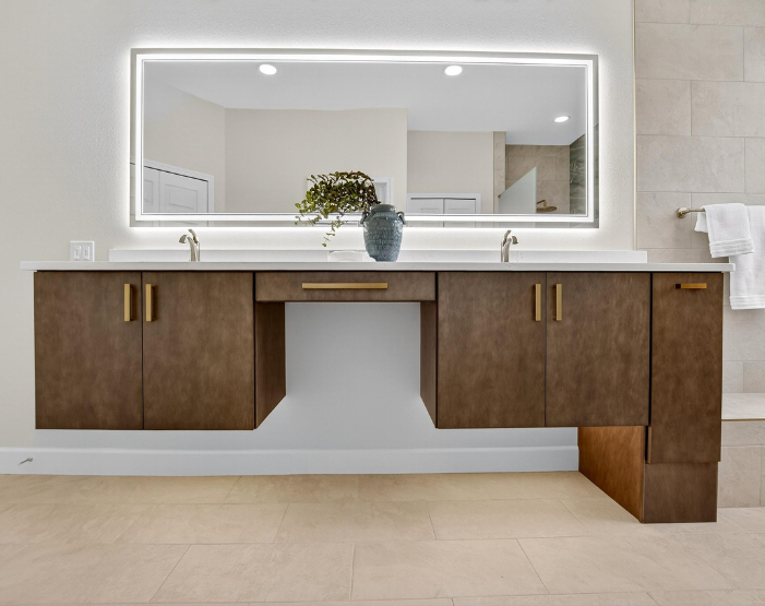 Custom vanity with gold hardware and under cabinet lighting