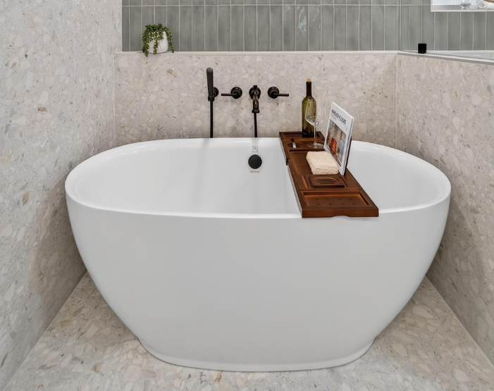 soaking tub with tile surround and black hardware in a bathroom remodel in Lutz, FL