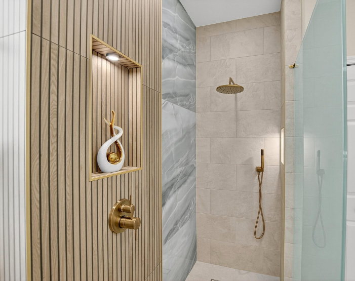 walk-in shower with wall tiled and reeded accent wall with lighted niche in Odessa, FL